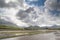 Clouds with blue sky over irish hills and estuary