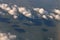 Clouds casting shadows on rippled water surface