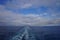 Clouds in a deep blue sky and the wake of a cruise ship in the Gulf of Alaska