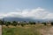 Clouds descend below the mountain peaks above the mountain city