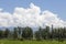 Clouds in dramatic formation over the chain of hills, and the row of trees