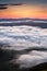 Clouds drenched valley below the level of the mountains.