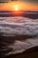 Clouds drenched valley below the level of the mountains.