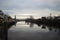 Clouds, factory and clouds reflecting in river Hollanse IJssel i