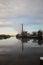 Clouds, factory and clouds reflecting in river Hollanse IJssel i