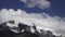 Clouds float over snow-covered slopes of Elbrus