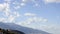 Clouds fly over mountains and medieval fortress