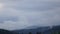 Clouds form over forest on slopes of hills, time lapse