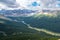 Clouds gathering above mighty rock massive of Evelyn Peak and green valley bellow. Cloudy summer day in Canadian Rockies. Bald