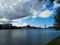 clouds are gathering over the river in the distance you can see the pier with boats on the left bank high-rise buildings