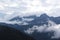 Clouds hanging over rugged mountains in Southern Alaska