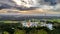 clouds hovers over a city with an old clock tower