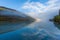 Clouds mirrored in lake Svartisvatnet in morning light