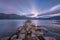 Clouds movements over a stones jetty at dawn at Lake Wanaka in New Zealand