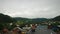 Clouds moving fast through mountain valley. Fluffy rainy clouds moving over mountain village. Beautiful cloudscape against mountai