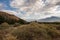 Clouds over California meadow with hills and mountain in distance