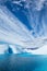 Clouds over deep blue glacial lake and ice cave on the Matanuska Glacier in Alaska