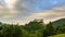 Clouds over historic castle in green forest country in evening Time lapse