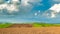 Clouds over plowed fields. Spring in sunny weather.