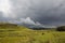 Clouds, rain and a small rainbow