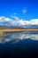 Clouds reflected in a blue lake