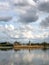 Clouds reflecting in lake, Herkenrode Abbey in the distance, Belgium, Europe