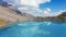 Clouds reflection on mirror lake on mountains in Switzerland. Aerial view 4K.