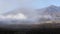 Clouds Rolling Across Plains Near Volcano