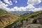 Clouds rolling over peaks and green valleys of the Western Tian Shan mountains, Uzbekistan