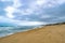 Clouds, Sand, and Surfers