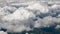 Clouds seen from flying plane. Skyscape with cloud from the plane window midair. Spectacular view from the window of an