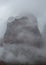 Clouds shroud a high red sandstone peak in Zion National park Utah