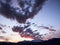 Clouds in the sky appear to be a giant genie coming out of a mount