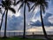 Clouds sky after storm, tropical beach with palm trees