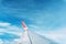 Clouds, sky and wing aeroplane as seen through window of an aircraft