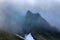 Clouds slide over from glacier and cliff to sea