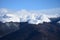 Clouds in snowy mountain tops in winter in Busteni Romania