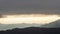 Clouds and sun in mountain landscape in Spain