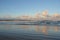 Clouds at sunset refected in the ripples on a beach.