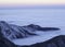 Clouds to the horizon over frozen mountains