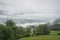 Clouds in a valley on a misty morning in the european Alps