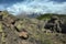 Cloudscape on encrusted volcanic rock and Etna Mount