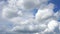 Cloudscape with large, moving clouds and blue sky