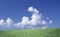 Cloudscape over green field