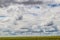 Cloudscape on the plains with windmill in the distance - Big sky country
