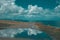 Cloudscape reflected in the water, turquoise seascape on the background