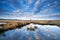 Cloudscape reflected in wild lake