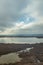 Cloudscape reflecting on quiet wetlands lake water in Camargue, France