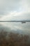 Cloudscape reflecting on quiet wetlands lake water in Camargue, France