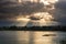 Cloudscape and sunbeams on lake